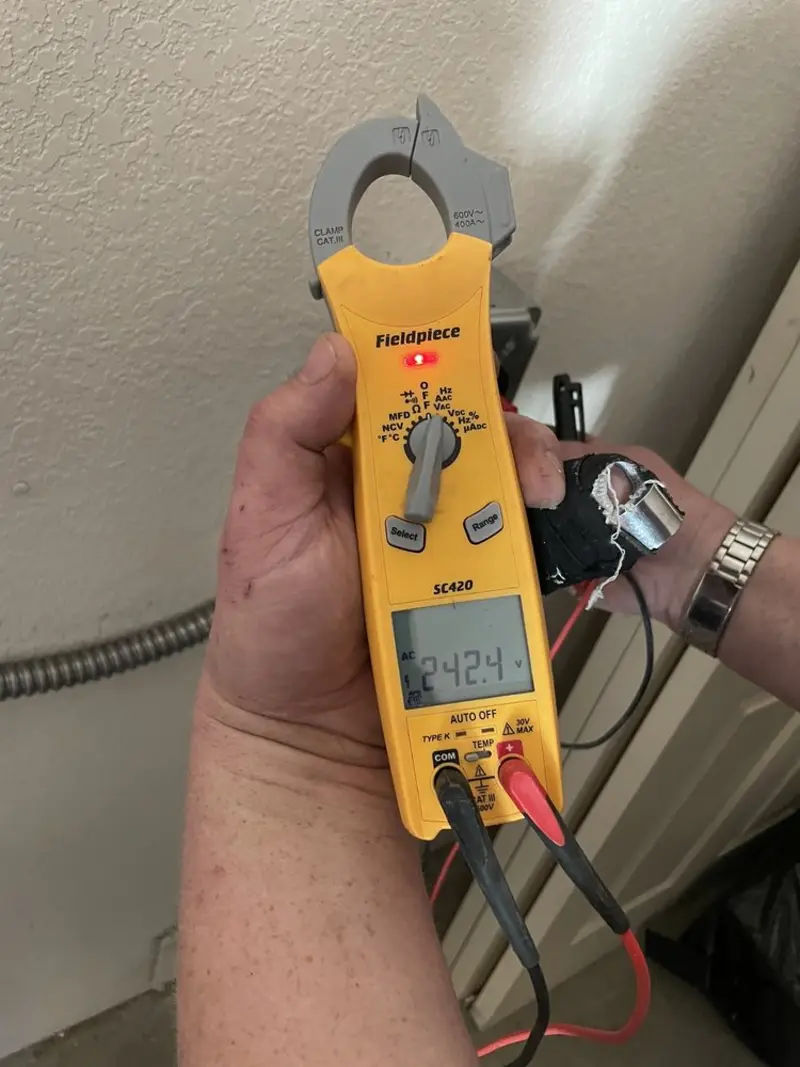 Voltage testing with clamp meter during Whole House Surge Protector in Essex